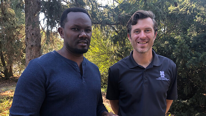 Samuel Nshutiyayesu (left) in a blue long-sleeve shirt and Daniel Uden (right) in a blue polo shirt.